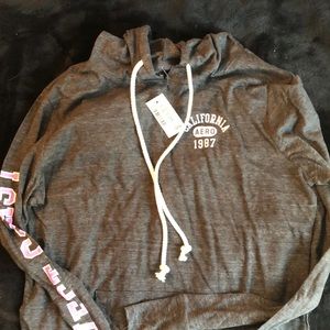 Light hooded shirt, grey with pink writing on arm